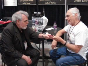 Discussing the specs of the banjo capo with Eddie at the Summer NAMM show in Nashville.